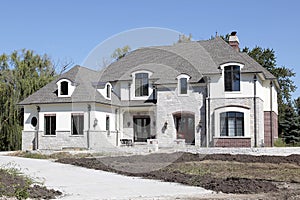 New construction home with unfinished landscaping