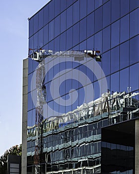 New construction reflected on a glass facade