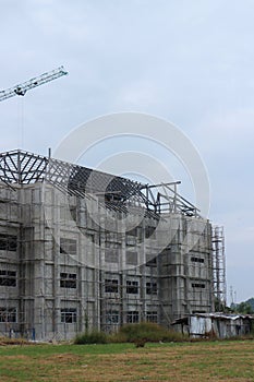New construction site with crane Sunset sky background Steel frame structure, steel beam Building a large building