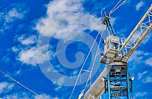 New construction site with cranes on blue sky background. Steel frame structure, structural steel beam, construction business