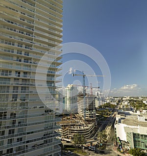 New construction site of developing residense in american urban area. Industrial tower lifting cranes in Miami, Florida