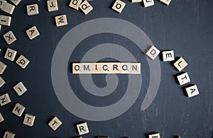 The word omicron written with wooden cube letters photo