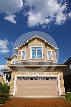 New cottage with garage in front of it.