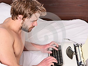 New day brings fresh ideas. Morning inspiration. Writer use manual typewriter daily work. Man writer lay bed working on