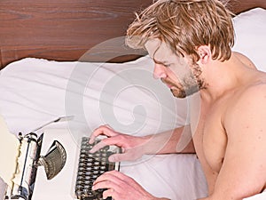 New day brings fresh ideas. Morning inspiration. Writer use manual typewriter daily work. Man writer lay bed working on