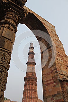 New Delhi, India - October 2014: Qutub minar, new delhi framed in a stone gate