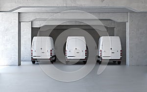 New delivery vans at parking with concrete walls
