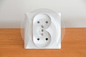 New double electric socket type E on wooden table