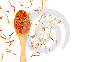 New Dried Safflower petals herb Tea on a wooden spoon.  on a white background