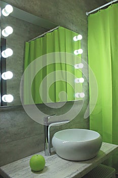 New ecological bathroom design. Light grey and green restroom with mirror and sink and shelves. Modern bathroom and toilet design.