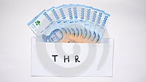 New edition of Indonesian banknotes in a white envelope for THR (tunjangan hari raya) and salary