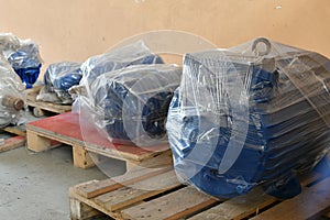 New electric motors are wrapped with packaging in the warehouse