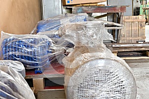 New electric motors are wrapped with packaging in the warehouse