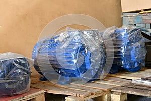 New electric motors are wrapped with packaging in the warehouse