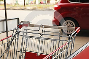 New empty metal shopping cart outdoors, closeup