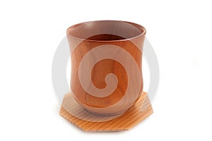 New empty wooden cup and plate on a white background.
