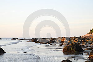 New England beach at low tide with morning sunlight