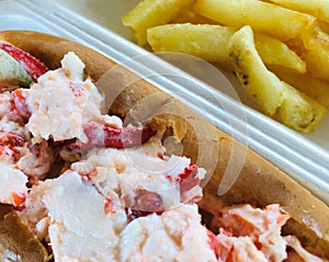 New england lobster roll , plump juicy claws and tail