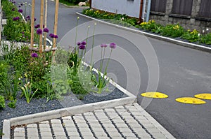 New established street in the city, the longitudinal parking lot is made of gray concrete infiltrating tiles with crevices filled