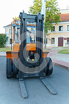 A new forklift truck stands on the street at an exhibition of new equipment. Front projection on the loader