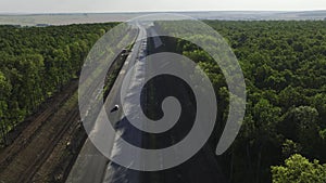 New freeway stretches to horizon among dense green forests