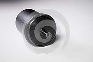 New fuel filter in a black plastic housing for diesel and gasoline engines on a gray background