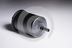 New fuel filter in a black plastic housing for diesel and gasoline engines on a gray background