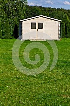 New garden house or shed in green lawn or grass