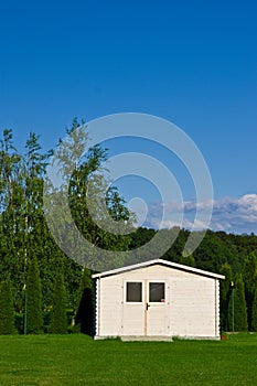 New garden house or shed in green lawn or grass