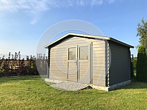 New garden house or shed in green lawn or grass