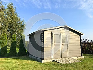 New garden house or shed in green lawn or grass