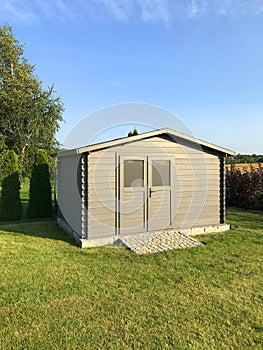 New garden house or shed in green lawn or grass