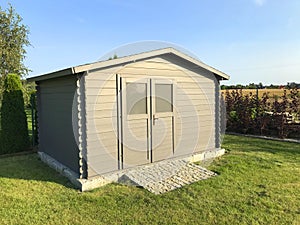 New garden house or shed in green lawn or grass