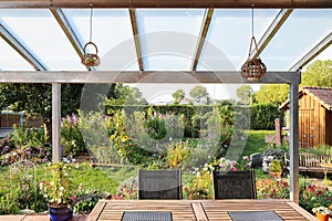 Terrace with glass roofing and a view of the garden photo