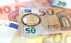 New Golden bitcoin on fifty euro banknotes background. Bitcoin crypto currency, Blockchain technology, digital money