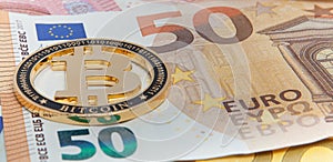 New Golden bitcoin on fifty euro banknotes background. Bitcoin crypto currency, Blockchain technology, digital money, Mining conce