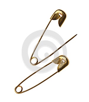 New golden safety pins on white background