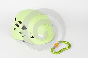 New green climbing helmet and green  HMS carabiner, screw lock snap hook, climbing  equipment on white background