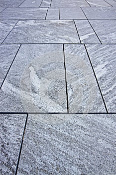 New grey paving made with stone blocks of rectangular shape in a pedestrian zone