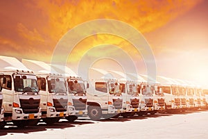 New haulage truck fleet is parking narrow at yard with sunset photo