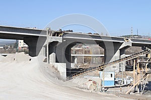 New highway under construction. A new bridge freeway made of concrete and metal to pass traffic from big city