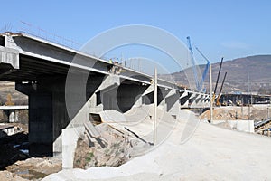 New highway under construction. A new bridge freeway made of concrete and metal to pass traffic from big city