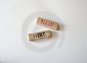 New hire symbol. Wooden blocks with words New hire. Beautiful white background. Business and New hire concept. Copy space