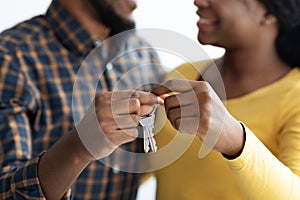 New Home Concept. Closeup Shot Of Happy Black Couple Holding Keys Together