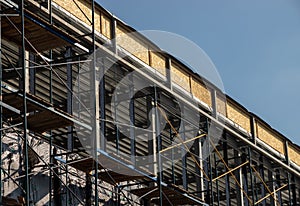 New home Construction of a cement block home with wooden roof trusses view from outside looking in