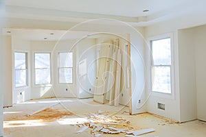 New home construction interior room with unfinished wood floors and twin closets.