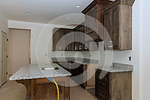 New home is currently being constructed with a custom modular kitchen that consists of cabinets with an island in center