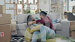New home, pillow fight and couple on sofa, happy and bonding in living room, apartment or property. Funny, man and woman