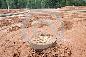 New home residential subdivision development manhole cover and concrete curbs