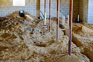 New home under construction plumbing sewer system pipes in home basement in the ground